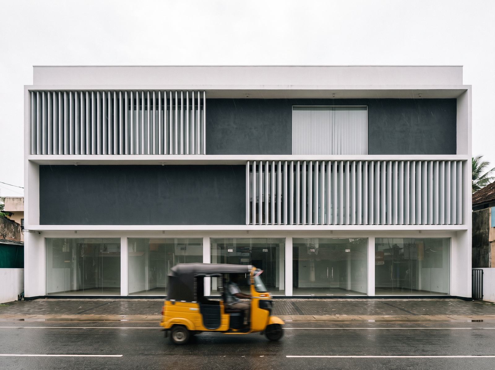 Three-storey commercial building with a glazed shopfront in Sri Lanka