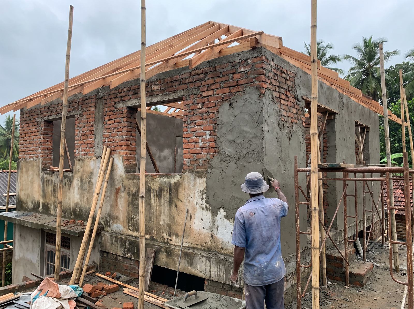 Unfinished house being completed with new plaster and roofing in Sri Lanka